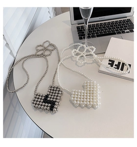 Detail of silver and white heart-shaped beaded mini cross-body bags for girls