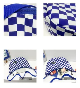 Detail of blue checkerboard canvas bag showing zipper closure and large storage capacity