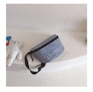 Detailed view of light blue boys chest bag with black adjustable strap and tootg print