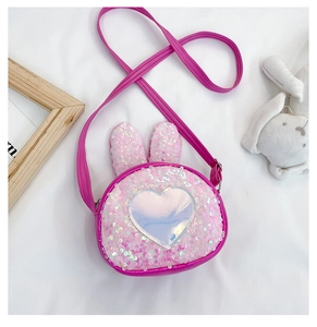 Detail of sequined bunny ear crossbody bag with holographic heart for young girls