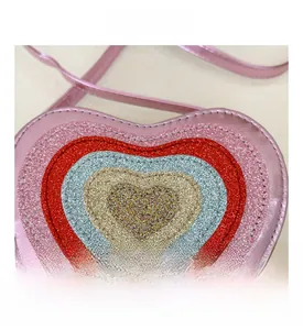Detail showing the layered glitter heart patterns and fine stitching on the heart-shaped bag