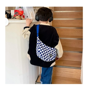 Kids blue checkerboard crossbody bag with adjustable strap shown on child model back