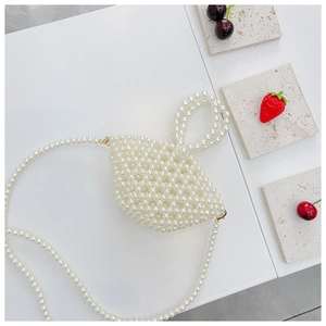 Detail of beaded pearl handbag for girls featuring golden metal rings and creamy finish