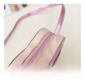 Detail showing smooth zipper closure and shimmering pink sequin fabric on kids crossbody bag