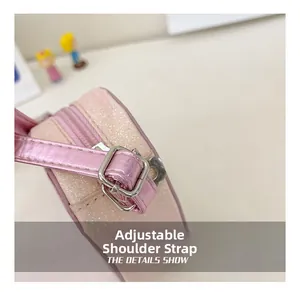 Detail of adjustable shoulder strap with silver buckle on pink sequin kids cross-body bag