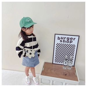 Girl's beaded flower pearl bag styled with a striped sweater and green baseball cap