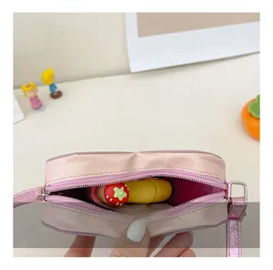 Detail view of pink glitter heart crossbody bag showing interior space and zipper