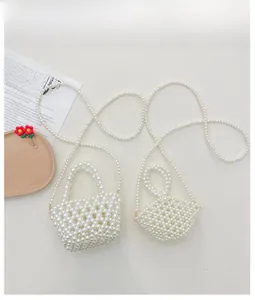 Detail shot of ivory beaded mini bags with glossy pearls and elegant woven textures