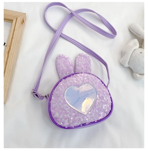 Detail of purple sequin kids bag with cute rabbit ears and laser heart patch