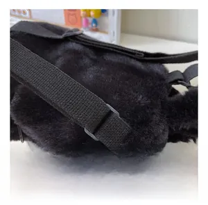 Close-up of black plush backpack featuring dense faux fur and adjustable nylon strap details