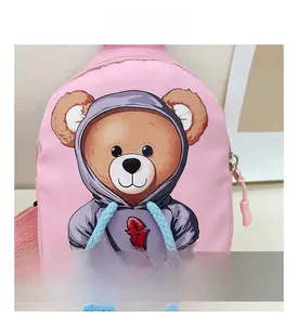 Close-up of pink canvas bag with cute cartoon bear print and blue braided drawstring