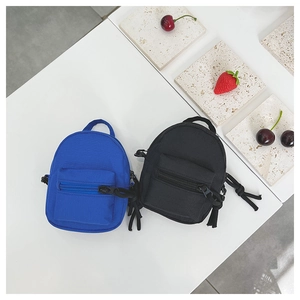 Miniature canvas shoulder bags for children in vibrant blue and classic black colors