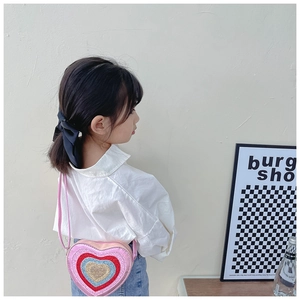 Detail of pink heart-shaped kids crossbody bag with vibrant multi-color sequins