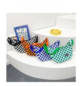 Detail of checkered crossbody bags in multiple colors with wide straps and fashion logo