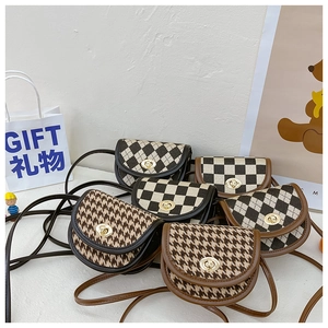 Detailed close-up of mini saddle bags with plaid, checkerboard and diamond patterns