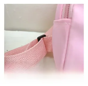 Detail showing high-quality stitching on pink shoulder strap with adjustable black buckle