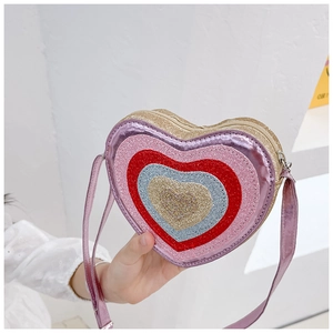 Detail of a kids heart-shaped glitter crossbody bag featuring multi-color sequin layers