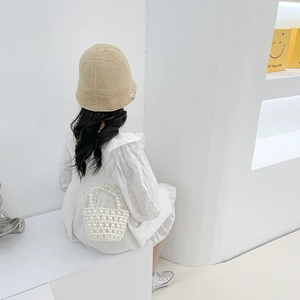 Mini pearl beaded handbag for girls featuring hand-woven design and elegant shoulder strap