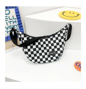 Close-up of black and white checkered kids crossbody bag with fashion leather patch
