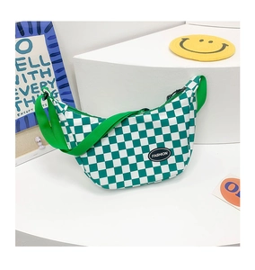 Detail of green checkerboard crossbody bag with adjustable strap and fashion label