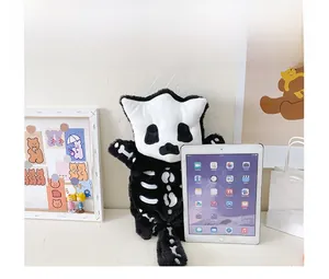 Close-up of black plush skeleton backpack size comparison with a tablet device