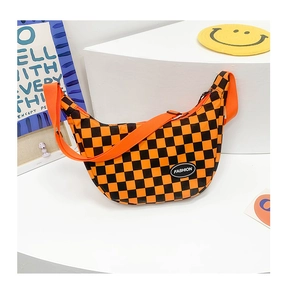 Detail view of checkerboard half-moon crossbody bag with orange wide strap and fashion label