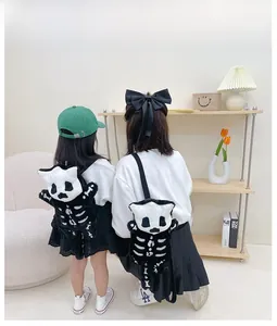 Detail showing matching parent and child plush skull backpacks for Halloween outfits