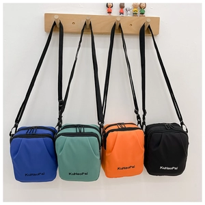 Detail of four colorful canvas crossbody bags with dual zippers and adjustable straps