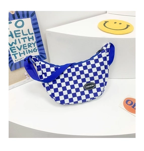Close-up of blue checkerboard crescent bag with adjustable strap and fashion label