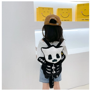 Close-up of plush Halloween cat skeleton backpack on a child with soft faux fur detail