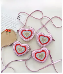 Flat lay detail of heart-shaped glitter bags on wooden tray with Vogue magazine