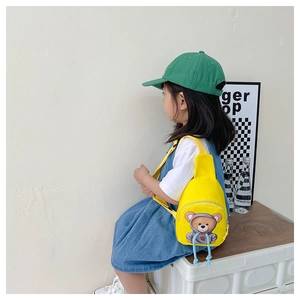 Detail showing the adjustable yellow strap and blue woven zipper pull on the kids' chest bag