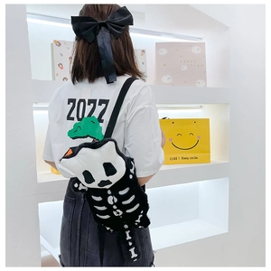 Close-up of plush panda skeleton crossbody bag worn by model in a modern shop setting