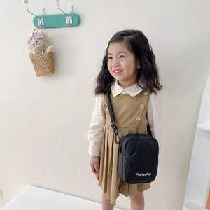 Minimalist black kids crossbody bag with adjustable shoulder strap and white logo