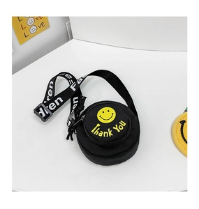 Detail einer Mini-Leinentasche in Schwarz mit gelbem Smiley und grafischem Schultergurt