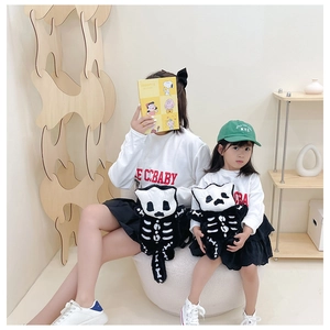 Detailed plush black cat backpack with white skeletal embroidery for kids and parents