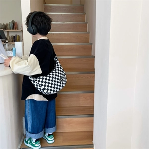Kids black and white checkerboard crossbody bag with adjustable wide shoulder strap