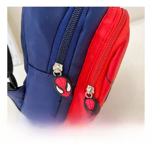 Close-up of Marvel Spider-Man themed silicone zipper pulls on a red and blue kids bag