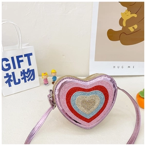 Detail of glitter pink heart crossbody bag featuring multi-layer colorful heart patterns