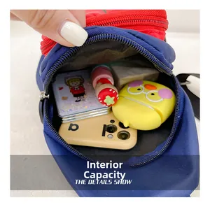 Internal capacity of the nylon crossbody bag showing phone and earphone case