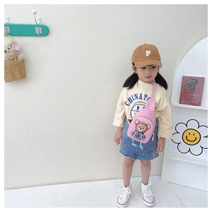 Pink canvas kids chest bag with bear print worn by a toddler for size reference