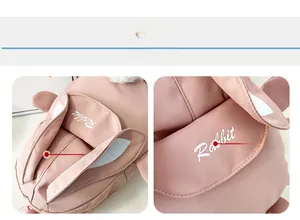 Close-up of pink rabbit backpack with 3D ears, plush ball and Rabbit print detail