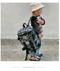 Detail of kids camo backpack with white NY embroidery and adjustable black shoulder straps