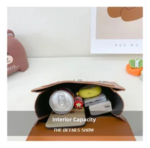 Internal capacity view of brown leather schoolbag showing storage for daily items