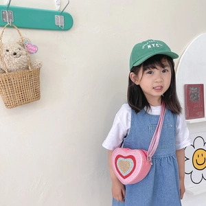 Pink heart-shaped crossbody bag for kids featuring colorful sequins and adjustable strap