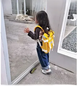 Detail shot of lightweight yellow nylon school backpack with NY logo embroidery for kids
