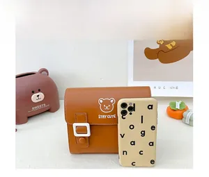 Detailed comparison showing the mini size of the brown bear PU leather crossbody bag