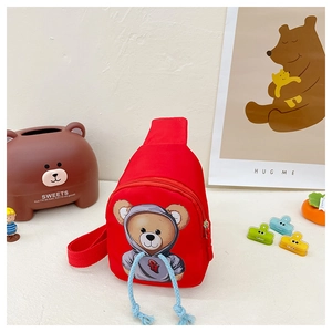 Detail of red kids canvas chest bag featuring cute brown bear print and thick strap