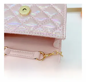 Detail of pink pearlescent mini bag showing golden magnetic closure and metal chain