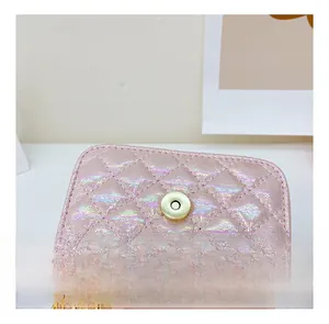Close-up of pink iridescent quilted leather with gold magnetic buckle on a mini bag